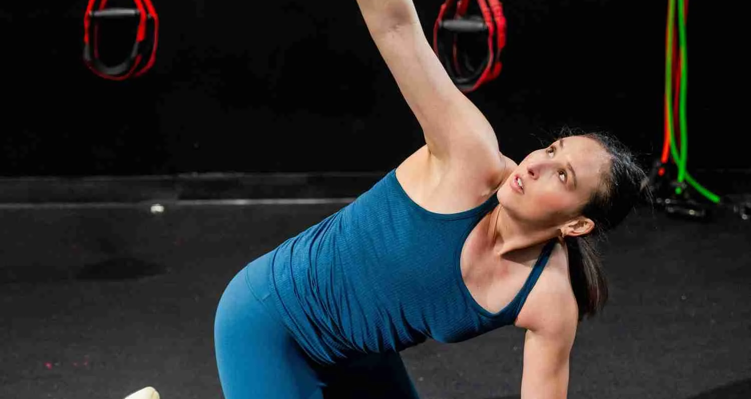 Trainer assisting a client with a shoulder stretch