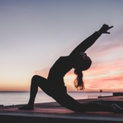 Person practicing yoga at sunset
