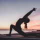 Person practicing yoga at sunset
